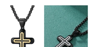 Close-up of cross pendant with round box chain and inlaid zircon in gold and silver