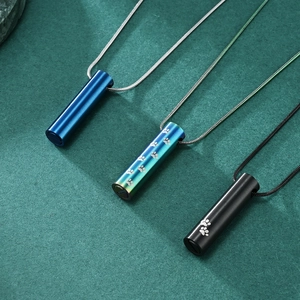 Three stainless steel pet cremation urn pendants in blue, rainbow, and black finishes