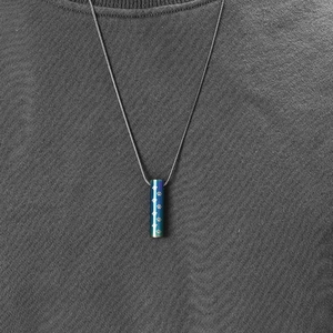 Blue-green gradient stainless steel pet urn necklace with laser-engraved paw prints