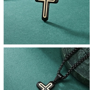 Detail of black polished cross pendant with gold inlay on dark marble display
