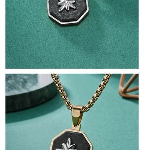 Close-up of golden octagonal pendant with black carbon fiber inlay and silver star emblem