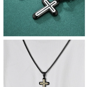 Close-up of minimalist black and silver cross pendant with small inlaid crystal on bead chain
