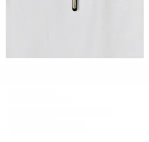 Detailed view of black and gold cross pendant with an official product care guide card