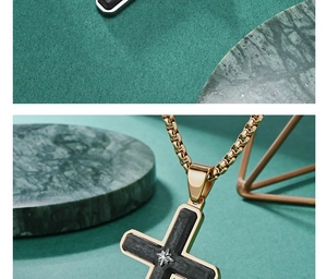 Detail of gold cross pendant with black forged carbon fiber inlay and star motif