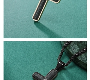 Detail of cross pendant featuring carbon fiber texture and golden stainless steel edges