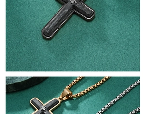 Close-up of forged carbon fiber cross pendant with diamond inlay and stainless box chain