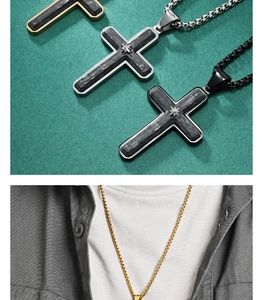 Close-up of forged carbon fiber cross pendant with diamond accents on box chain