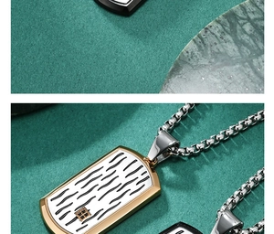 Macro detail of men's dog tag pendant with ripple texture and black stone accents