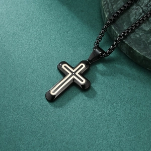 Modern black cross pendant necklace with centered stone inlay on dark green background