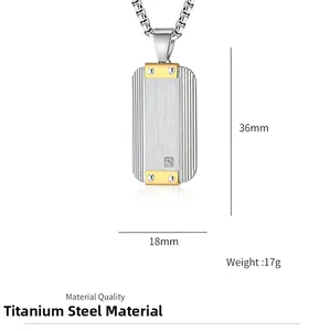 Detail of titanium steel rectangular pendant with silver texture and gold accents