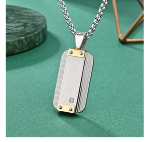 Macro view of brushed stainless steel military pendant with industrial rivet details