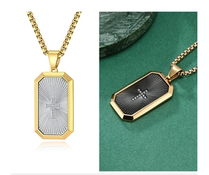 Detail view of cross pendant necklace with radiant texture in gold and silver finish