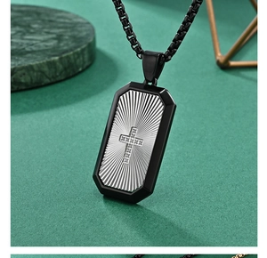 Macro view of two-tone hip hop dog tag pendant with detailed cross and sunburst texture