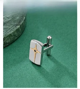 Detail of rectangular silver brushed cufflinks with a golden star and center crystal