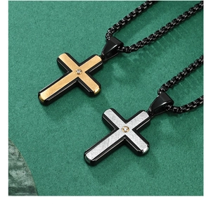 Detail of silver and gold textured cross pendants with zircon on industrial bead chain