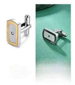 Macro detail of fan-textured stainless steel cufflinks with crystal inlay and brushed finish