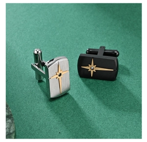Detail view of silver and black stainless steel cufflinks with gold star and zircon inlay