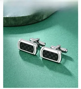 Detail of silver rectangular cufflinks with black carbon fiber checkerboard inlay pattern