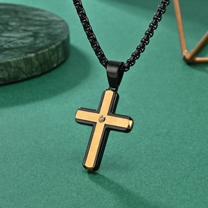 Classic two-tone cross pendant necklace in black and gold with a center crystal