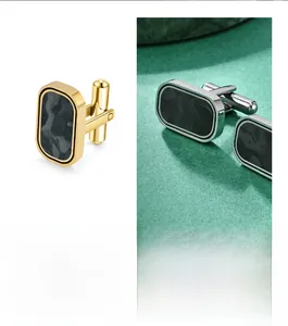 Detailed close-up of rectangular cufflinks with camouflage carbon fiber inlay and metallic frame