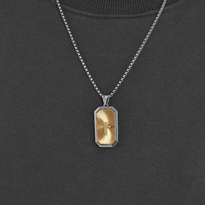 Two-tone octagonal cross pendant necklace with gold texture and cubic zirconia on steel chain