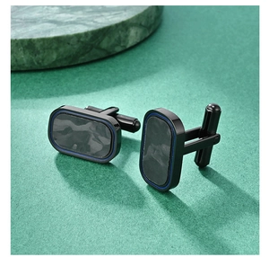 Macro detail of rectangle cufflinks with carbon fiber pattern and blue metallic borders