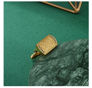Detail of gold cufflinks with Arabic engraving and black stones for business men