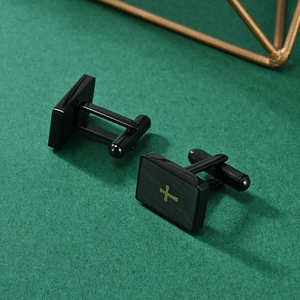 Men's rectangular black stainless steel cufflinks featuring a gold cross and brushed finish