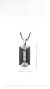 Detail of two-tone stainless steel rectangular pendant with vertical small crystals