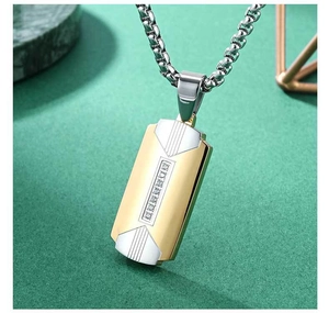 Macro detail of men's two-tone stainless steel pendant with industrial chain link