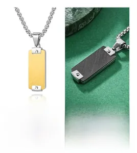 Macro detail of men's dog tag pendant with gold brushed finish and black carbon fiber texture