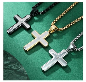 Detailed view of cross pendants in gold, silver, and black with central cubic zirconia