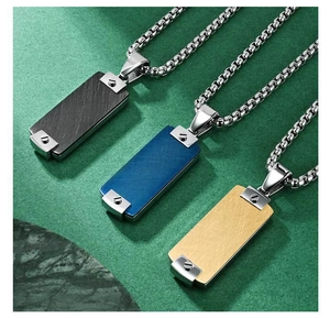 Detail of rectangular pendants with screw rivets in black, blue, and gold finishes
