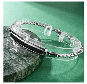Close-up of men's steel chain bracelet with a faceted black carbon fiber center piece