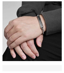 Detail of men's faceted V-groove camouflage carbon fiber bracelet on male wrist