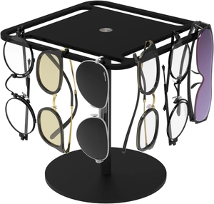 Close-up of a rotating black acrylic sunglasses display stand with multiple eyewear slots