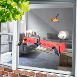 Window hummingbird feeder with suction cups and red flower ports for outdoor bird watching