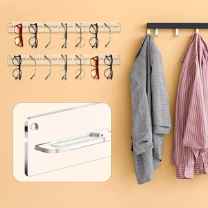 Detail showing wall-mounted acrylic wooden rack for organizing multiple sunglasses