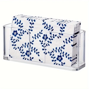 Close-up of clear acrylic guest towel holder with blue floral napkins for table storage