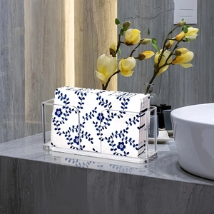 Modern clear acrylic guest towel holder with U-shaped opening on grey marble surface