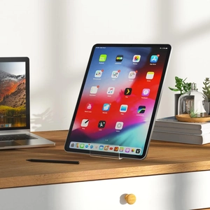 Macro view showing stable acrylic tablet holder on a wooden desk in a home office