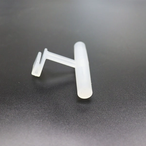 White acrylic T-shaped bird feeder perch clip and accessory on a black background