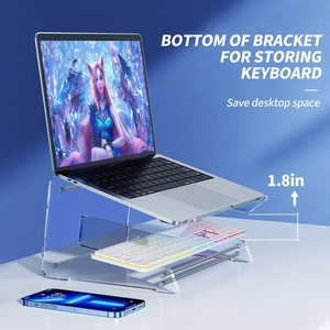 Transparent acrylic laptop riser with a dedicated keyboard storage slot on a clean desk