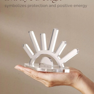 Detailed view of evil eye acrylic jewelry stand held in hand for scale and clarity