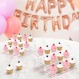 3-tier clear acrylic dessert stand showcasing cupcakes on a marble tabletop party setting