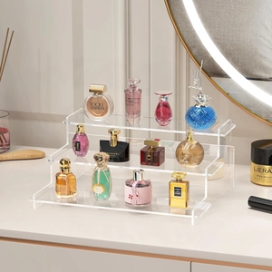 3-tier clear acrylic tiered display stand for perfumes and cosmetics on a modern vanity