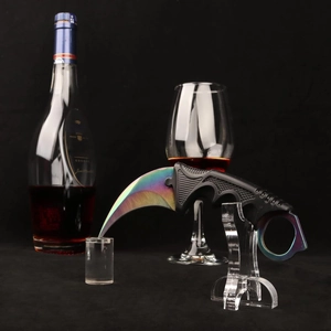 Acrylic cylinder stand holding a tactical karambit knife with a colorful rainbow blade finish