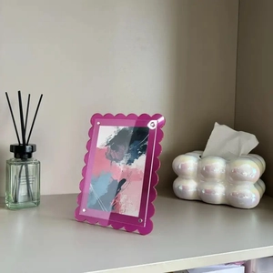 Vertical wavy acrylic photo frame in rose pink translucent finish with abstract art print