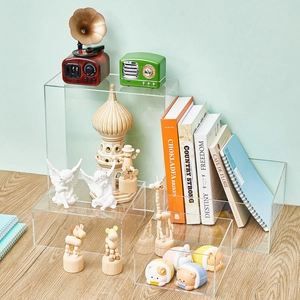 Detailed view of clear acrylic display risers on a desk showcasing mini collectibles