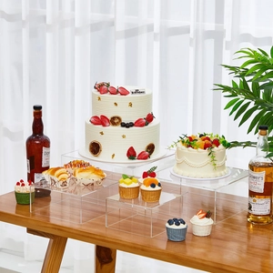 Set of 4 clear acrylic nesting display risers on wooden table for cake and figure displays